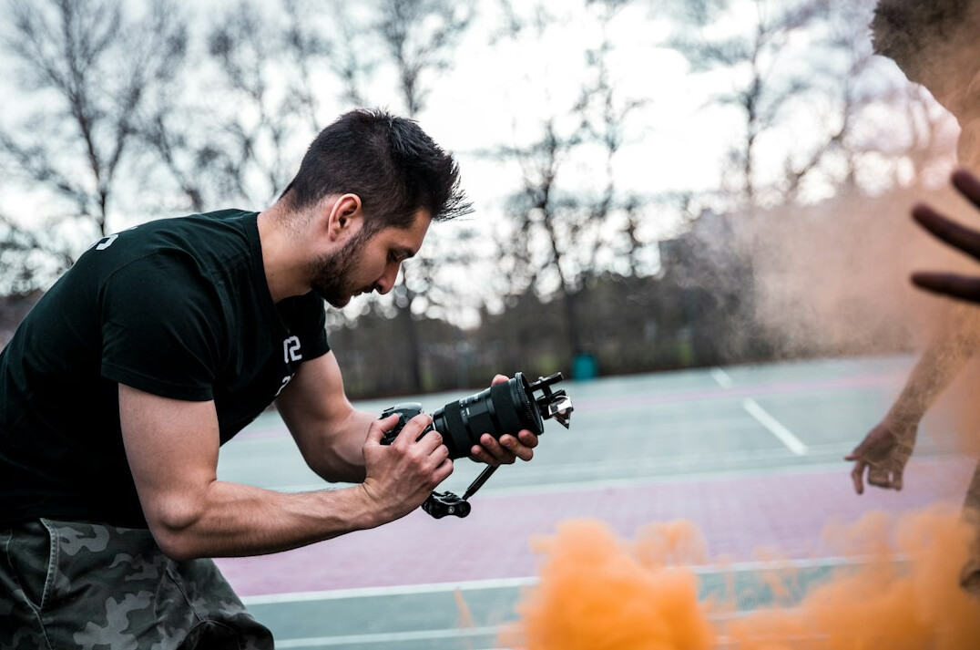 Man being filmed by a video camera during training